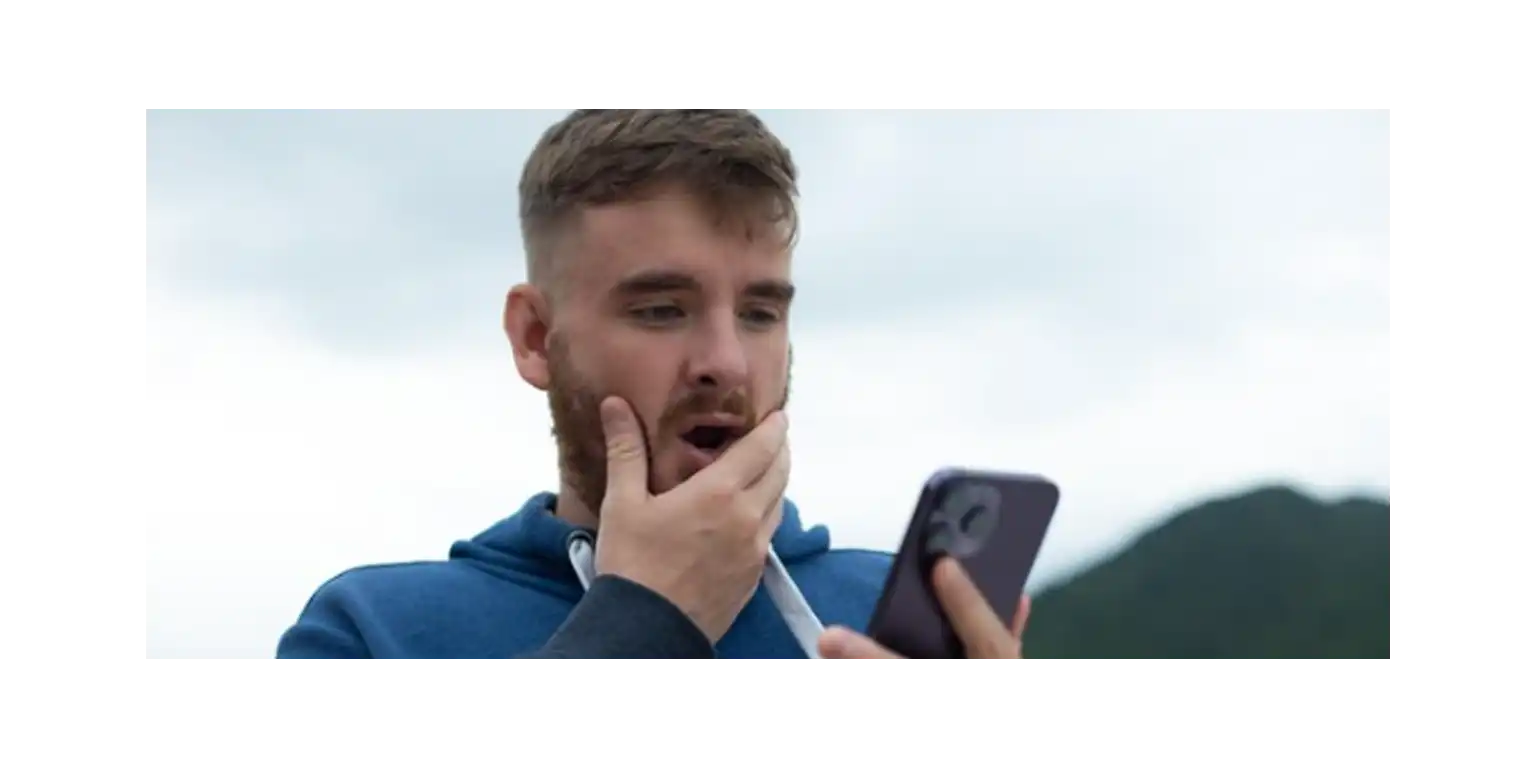 a sad man  his phone lies next to him