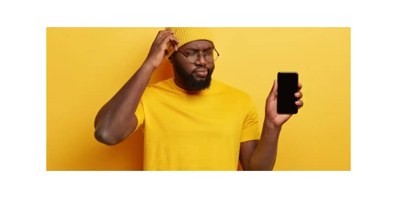 a man looks at the phone screen, thinks and rubs his chin